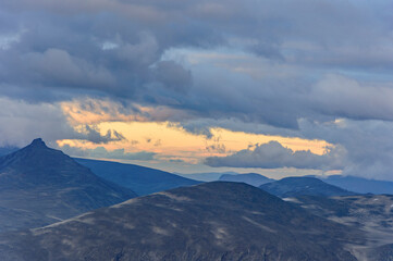 Summer sunset clouds over the mountains in Jotunheimen national park in Norway
