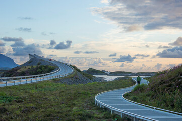 Evening at the viewpoint on the Atlantic road in Norway. Curved bridge, curved pedestrian road,...