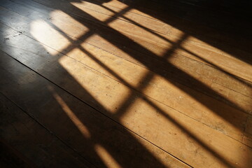 sunshine in morning through windows with shadows on wooden floor old background