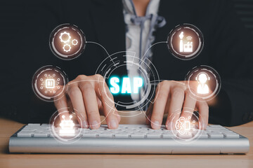 Fototapeta na wymiar SAP - Business process automation software and management software (SAP), Person hand typing on keyboard with ERP enterprise resources planning system concept on virtual screen.