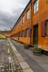 Fototapeta na wymiar Beautiful view of the Old orange houses in the famous Nyboder district. Copenhagen. Denmark