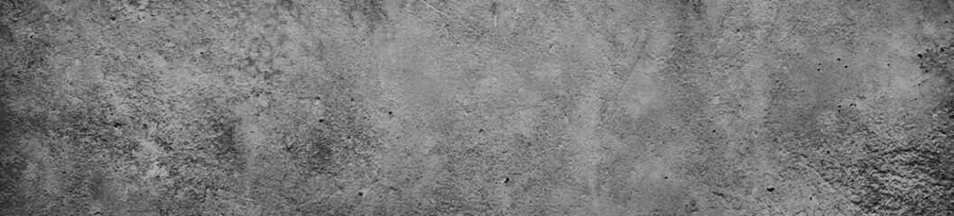 Black white concrete wall texture. Dark gray cement grunge background with space for design. Web banner. Wide. Website header. Panoramic.