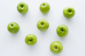 flat lay of green and ripe apples on white. - obrazy, fototapety, plakaty