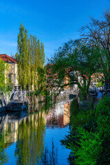 Fototapeta na wymiar Embankment of Ljubljanica river and old buildings in the historical center of Ljubljana, Slovenia at sunny spring day. Cityscape of the Slovenian capital Ljubljana over Ljubljanica river.