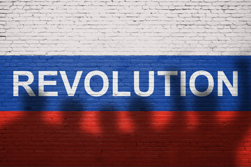 Flag of Russia painted on a brick wall with word REVOLUTION