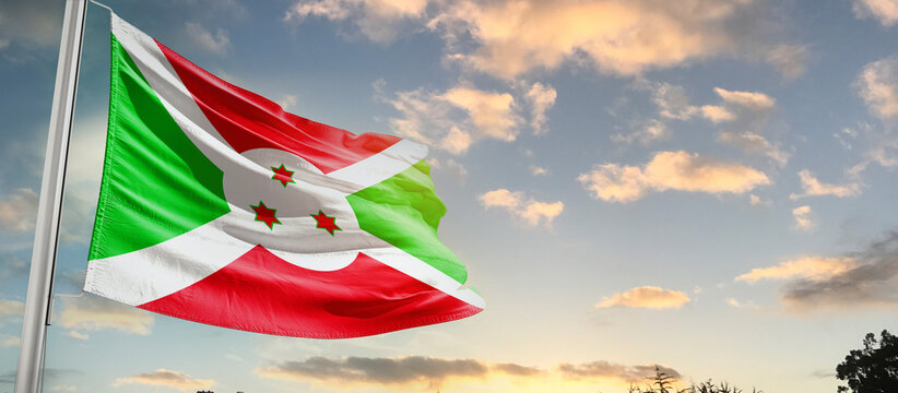 Burundi national flag cloth fabric waving on the sky - Image