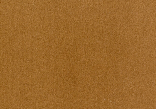 Highly detailed cardboard paper texture background fine grain caramel brown smooth uncoated corrugated fiberboard with copy space for text for material mockup or wallpaper