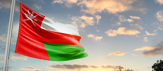 Oman national flag cloth fabric waving on the sky - Image - obrazy, fototapety, plakaty