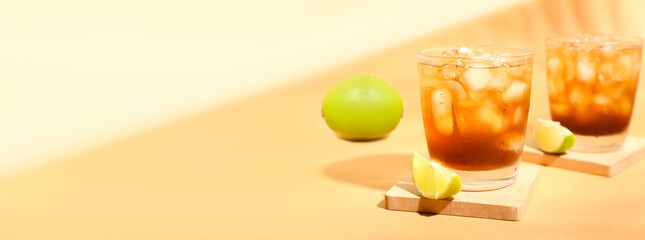 Glasses of tasty Long Island iced tea on color background with space for text