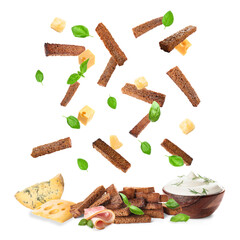 Falling rye croutons with cheese, basil leaves and sour cream on white background