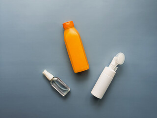 Top view of various plastic tubes: body lotion, facial wash, body oil. The concept of skin care after taking a shower. Blue background. Copy space. Place for text. Horizontally