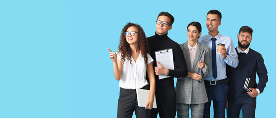 Naklejka premium Team of young business people on blue background with space for text