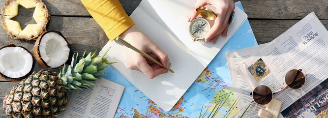 Female tourist at table planning her vacation, top view © Pixel-Shot