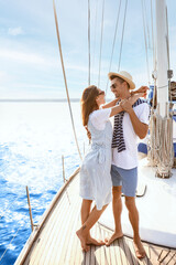 Happy young couple resting on yacht