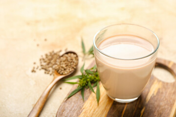 Glass of healthy hemp milk on light background, closeup
