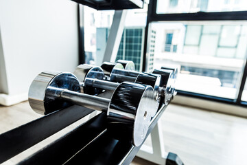 Row of weight dumbbell in fitness room sport background