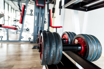 Fototapeta na wymiar Row of weight dumbbell in fitness room sport background