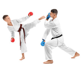 Boy practicing karate with instructor on white background