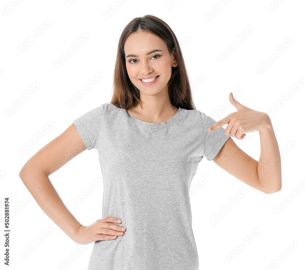 Wall mural Pretty young woman in stylish t-shirt on white background