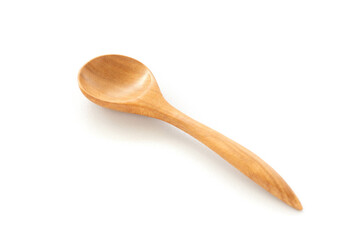 A wooden spoon is placed on a white ceramic background. Concept of isolated objects on a white background. Shot in natural light.
