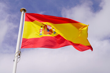 spain spanish flag float over sky in mat with wind - obrazy, fototapety, plakaty