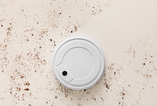 Modern Robot Vacuum Cleaner And Dirt On White Background