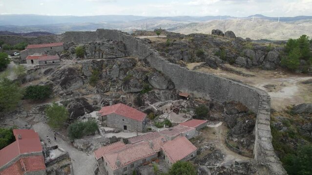 Ruins of defensive wall of Sortelha Fortress surrounding this historic village