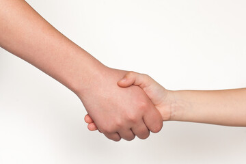 The hands of a child and an adult on a white background. People, Childhood, Gesture, The Concept of body parts.