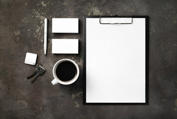 Branding stationery mockup, key and coffee cup on concrete background. Blank objects for placing your design. Flat lay.
