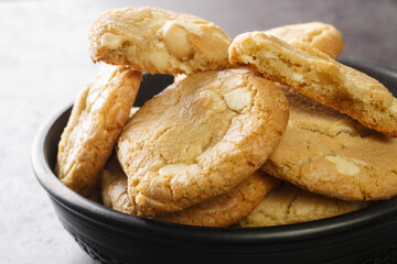 Homebaked white chocolate chip cookies with macadamia nuts on the table close-up. Horizontal