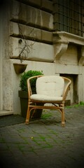 Armchair in front of old building
