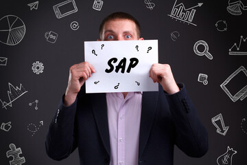 Business, technology, internet and network concept. Young businessman thinks over the steps for successful growth: SAP