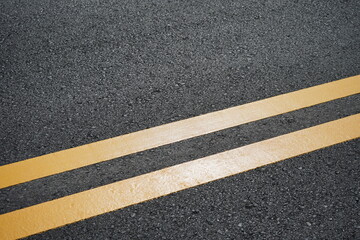 Fototapeta premium Blurred image, paved road and yellow traffic markings