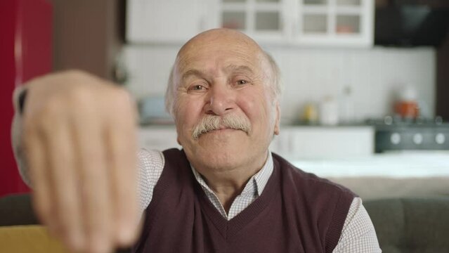 Portrait of human hand showing to camera. Hand kissing.The old man who extends her hand to kiss her visitors during the feast (Ramadan or Şeker Bayram). People who adhere to Muslim traditions.