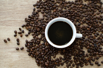 Coffee background in cup on wooden table with flat space for text.