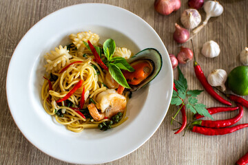 Plate of delicious pasta with mushrooms on table