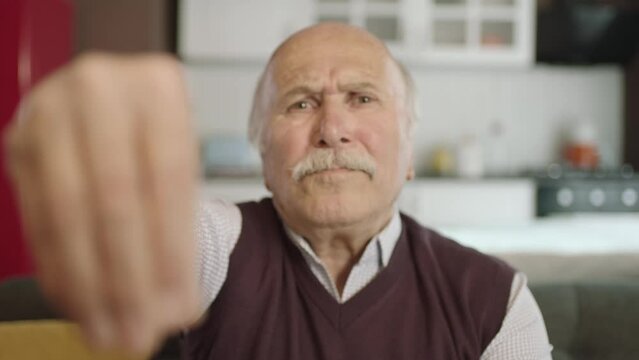 Portrait of human hand showing to camera. Hand kissing.The old man who extends her hand to kiss her visitors during the feast (Ramadan or Şeker Bayram). People who adhere to Muslim traditions.
