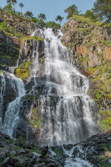 Close-up vertical shot of waterfall with vegetation on the sides in southern Chile