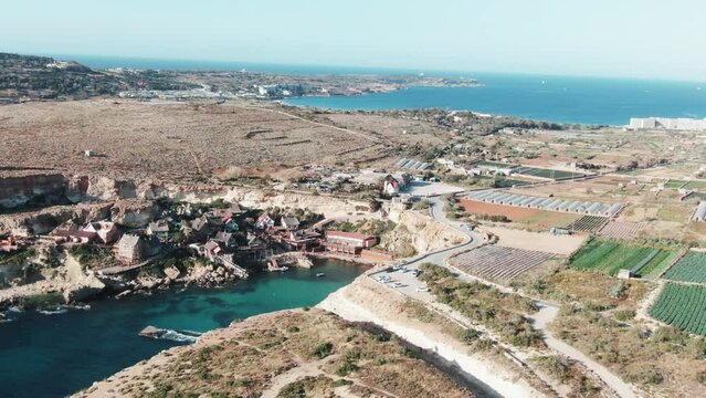 Aerial view of Popeye Village. Sunny day, blue sea, blue sky. Mellieha city. Top view. Europe. Malta country