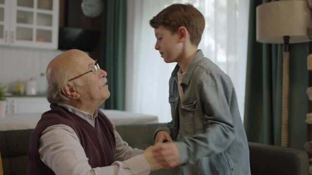 The child kisses his grandfather's hand, celebrates Eid or Father's Day.A child kissing his grandfather's hands during the feast (Ramadan or Şeker Bayram). People who adhere to Muslim traditions.