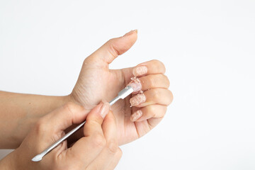 Liquid for home removal of gel nail polish in action on a woman's hand