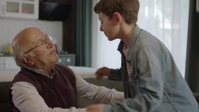 The child kisses his grandfather's hand, celebrates Eid or Father's Day,A child kissing his grandfather's hands during the feast (Ramadan or Şeker Bayram). People who adhere to Muslim traditions.
