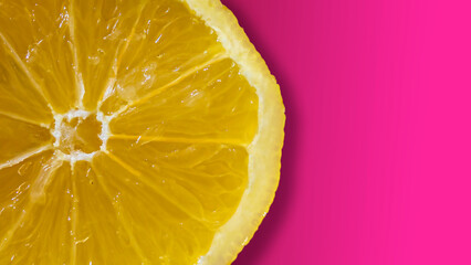 Lemon wedge on pink background