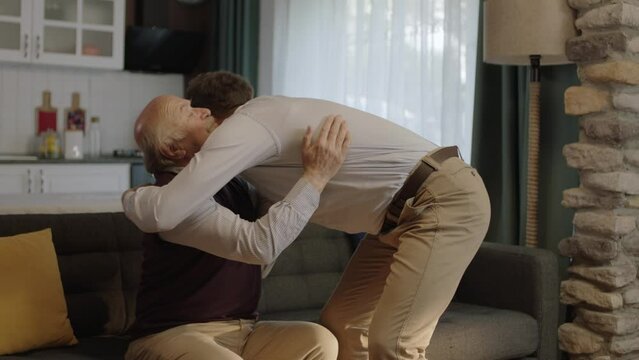 A man kissing his father's hands, celebrating holidays or father's Day.Young man kissing his old father's hands during the feast (Ramadan or Şeker Bayram). People who follow Muslim traditions.