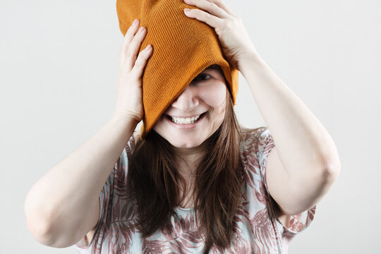 Cheerful hipster woman wearing winter knitted hat.