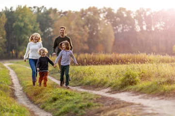 Fotobehang Young family having fun outdoors  © pikselstock