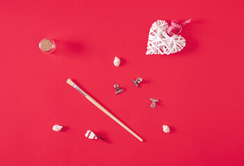 Everyday objects lay down on pastel red background. Minimal horizontal flat lay composition, decorative design concept