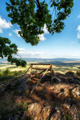 Lonely empty bench with beautiful view on summer countryside on hill called Ondrasovska skala, Slovakia
