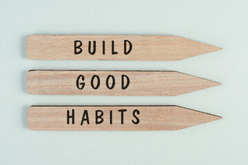 The words build good habits are standing on arrows, change lifestyle, healthy and positive...