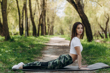 Young woman doing yoga in morning park